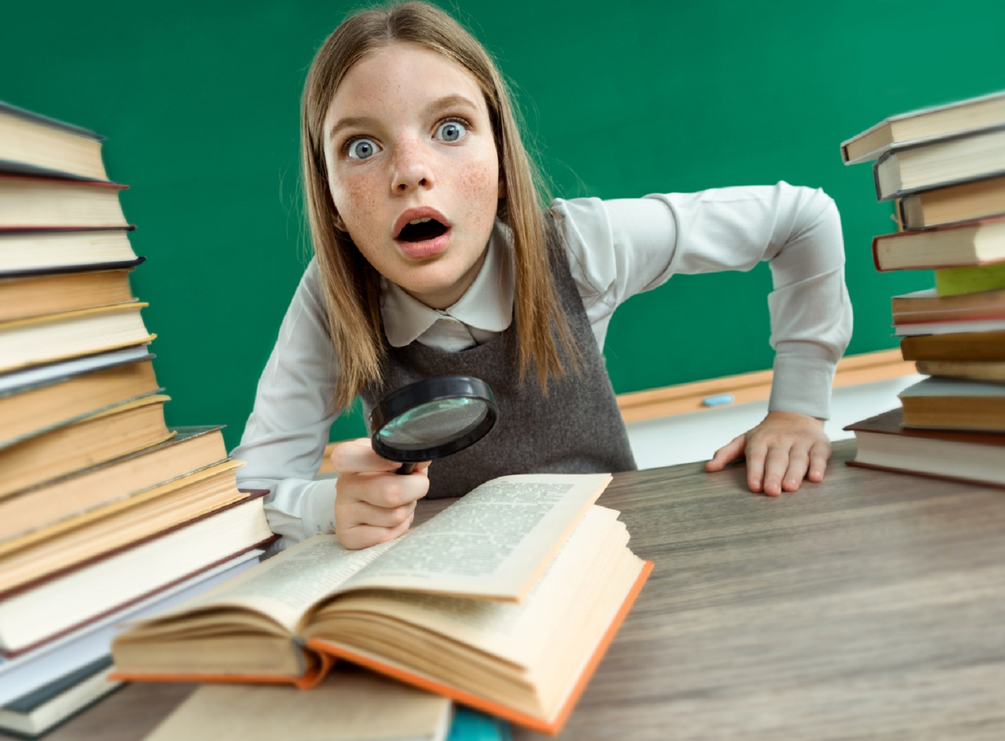 Girl open-eyed reading book