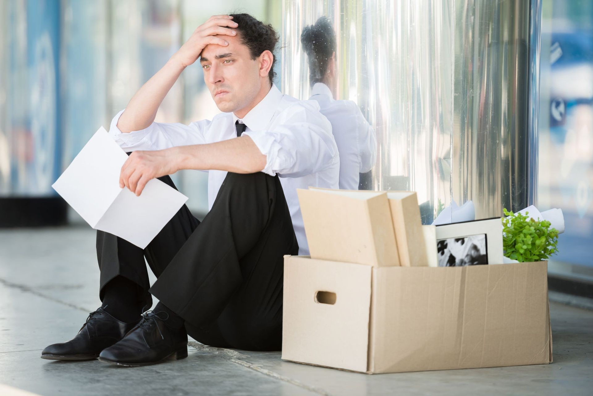 40997622 – fired frustrated man in suit sitting near office.