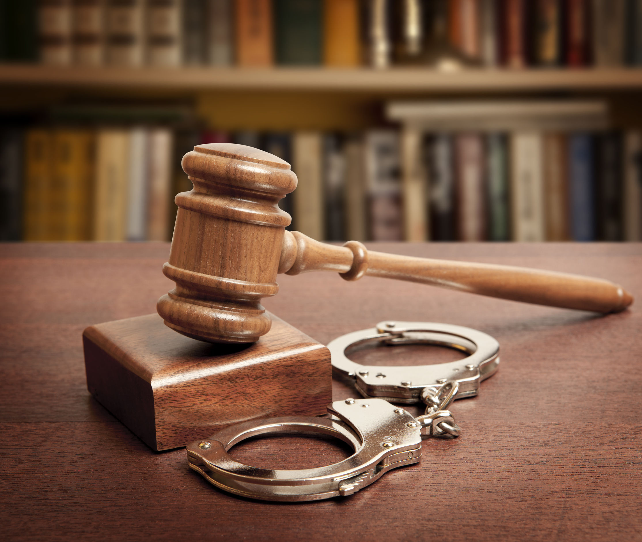 49176695 – gavel and handcuffs on wooden background