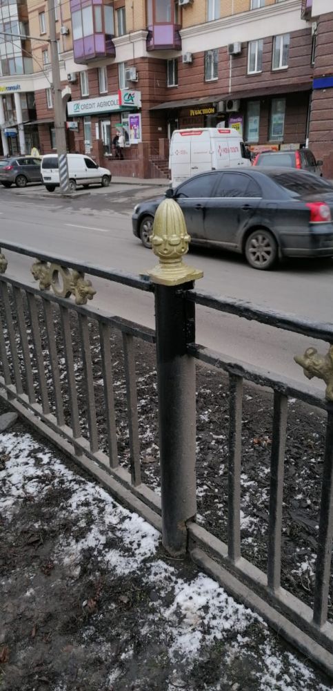 Встановлюють чавунні "шишки" на паркан